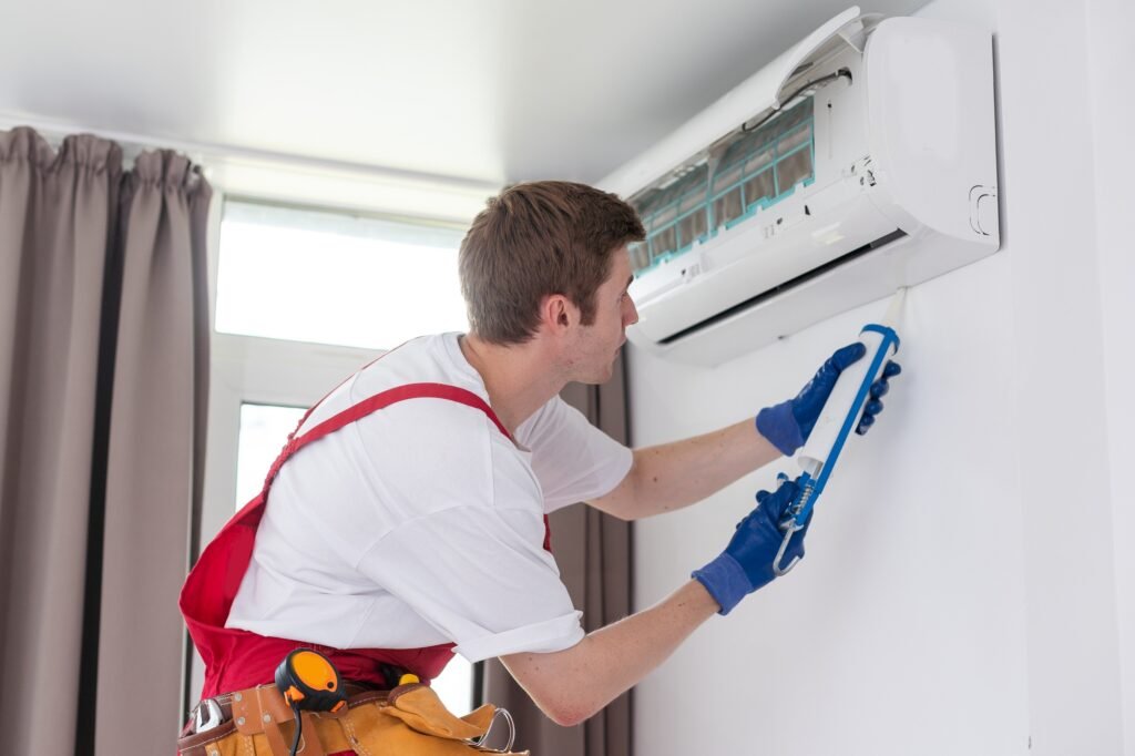 technician service removing air filter of the air conditioner for cleaning.